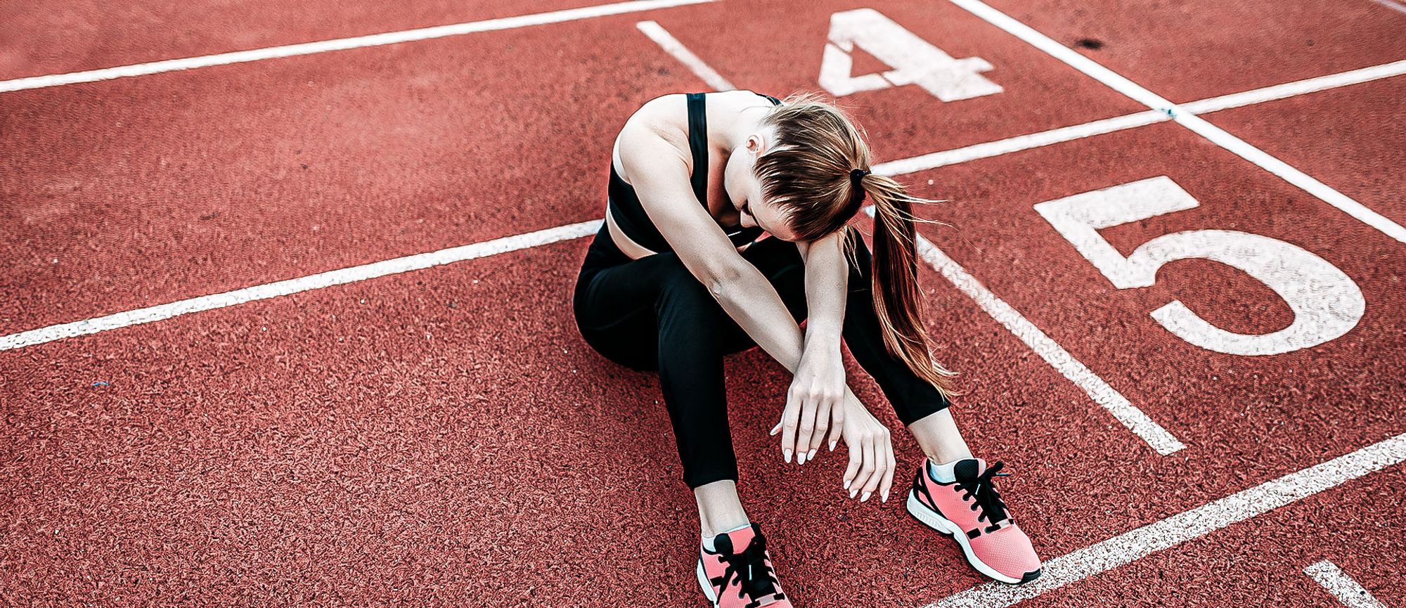 exhausted female runner stadium